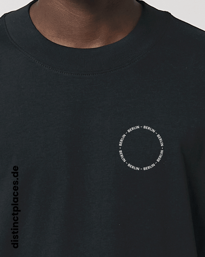 Detailansicht schwarzes fairtrade, vegan und bio-baumwoll Oversized T-Shirt von vorne mit einem minimalistischem weißen Logo, beziehungsweise Schriftzug für Berlin